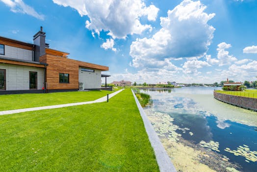 A modern lakeside villa with serene surroundings and a beautiful pond, perfect for peaceful living.